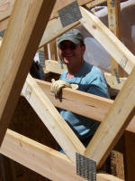 Worker smiling though truses