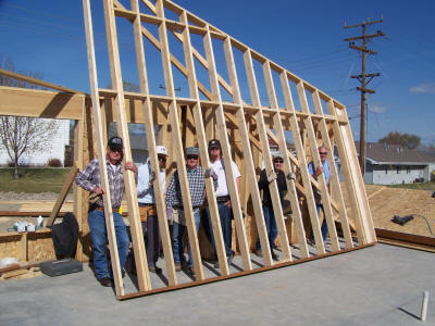 Workers peering through skeleton wall