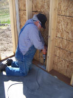 Worker drilling into floor